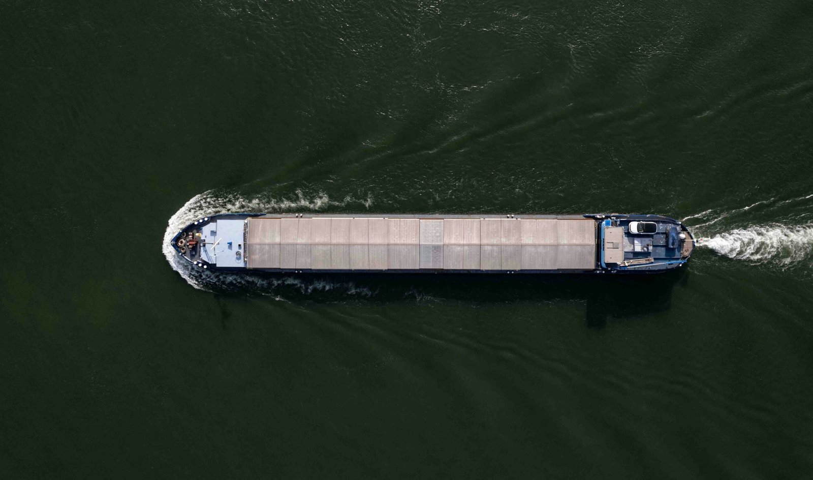 a boat is traveling on the water near a dock