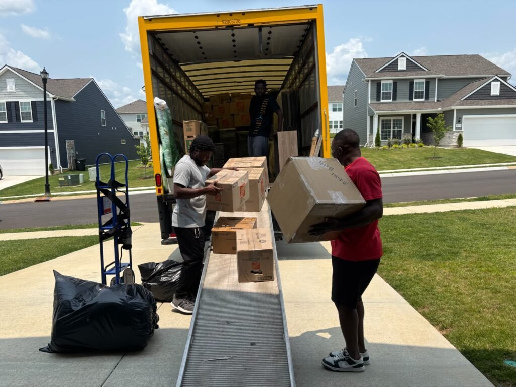 JM Moving, Movers unloading boxes from truck