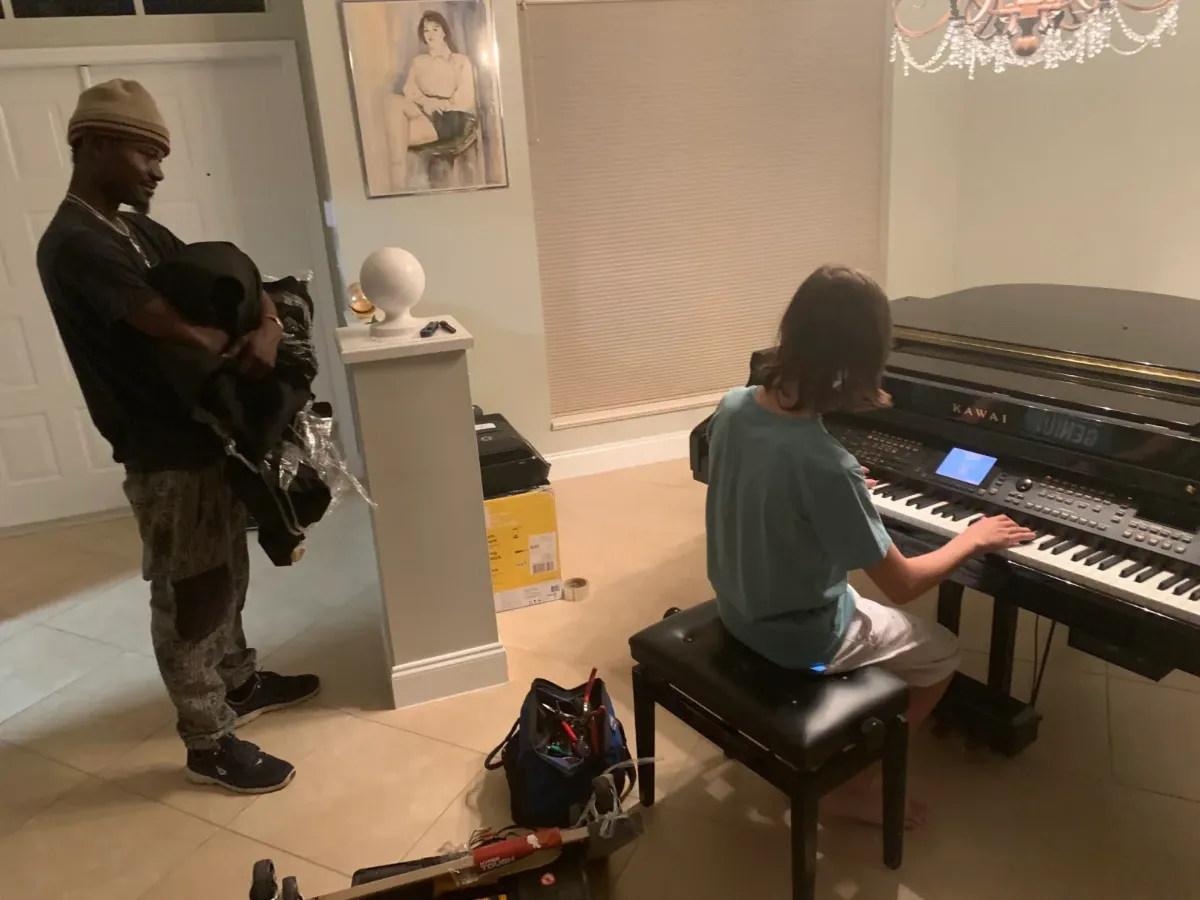 Piano movers Nashville TN preparing an upright piano for a local move