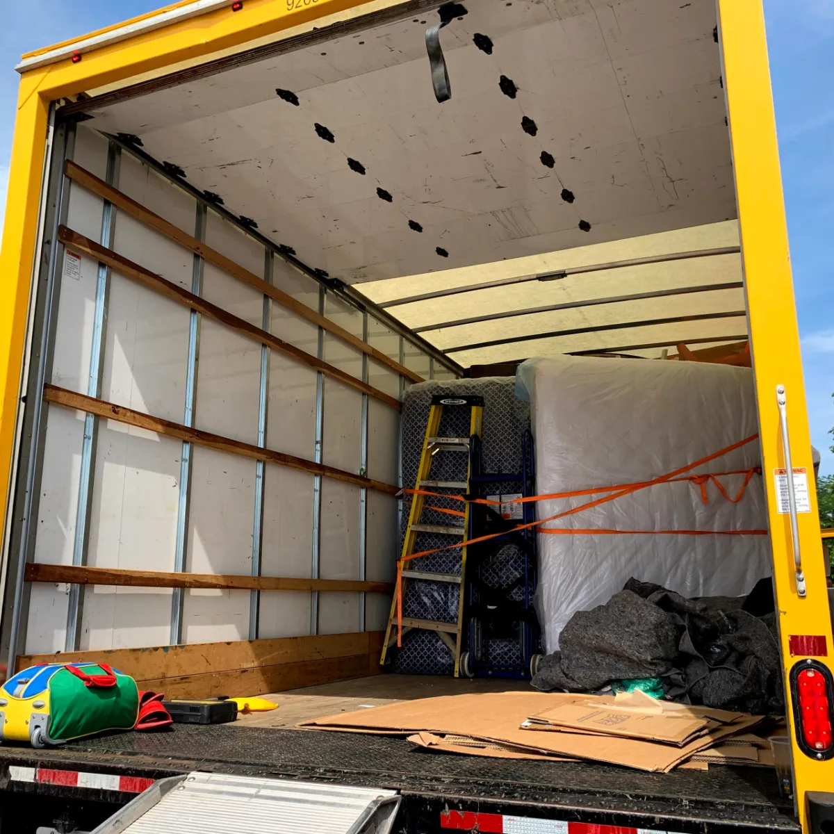 Nashville movers loading furniture onto a JM Moving truck