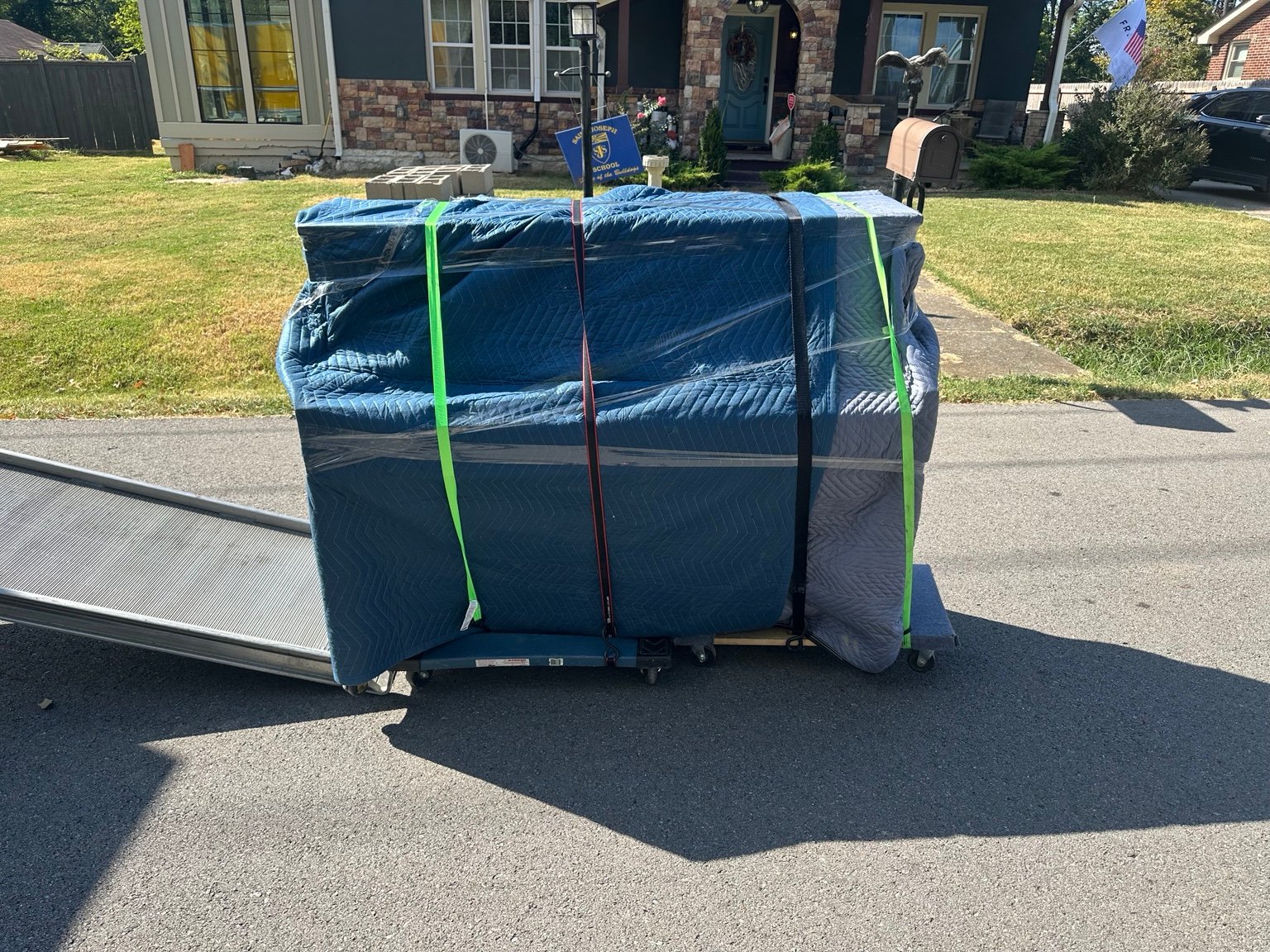 Wrapped upright piano ready for careful Nashville moving