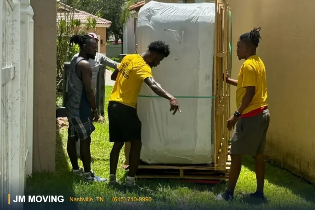 JM Moving crew moving a heavy item in Nashville